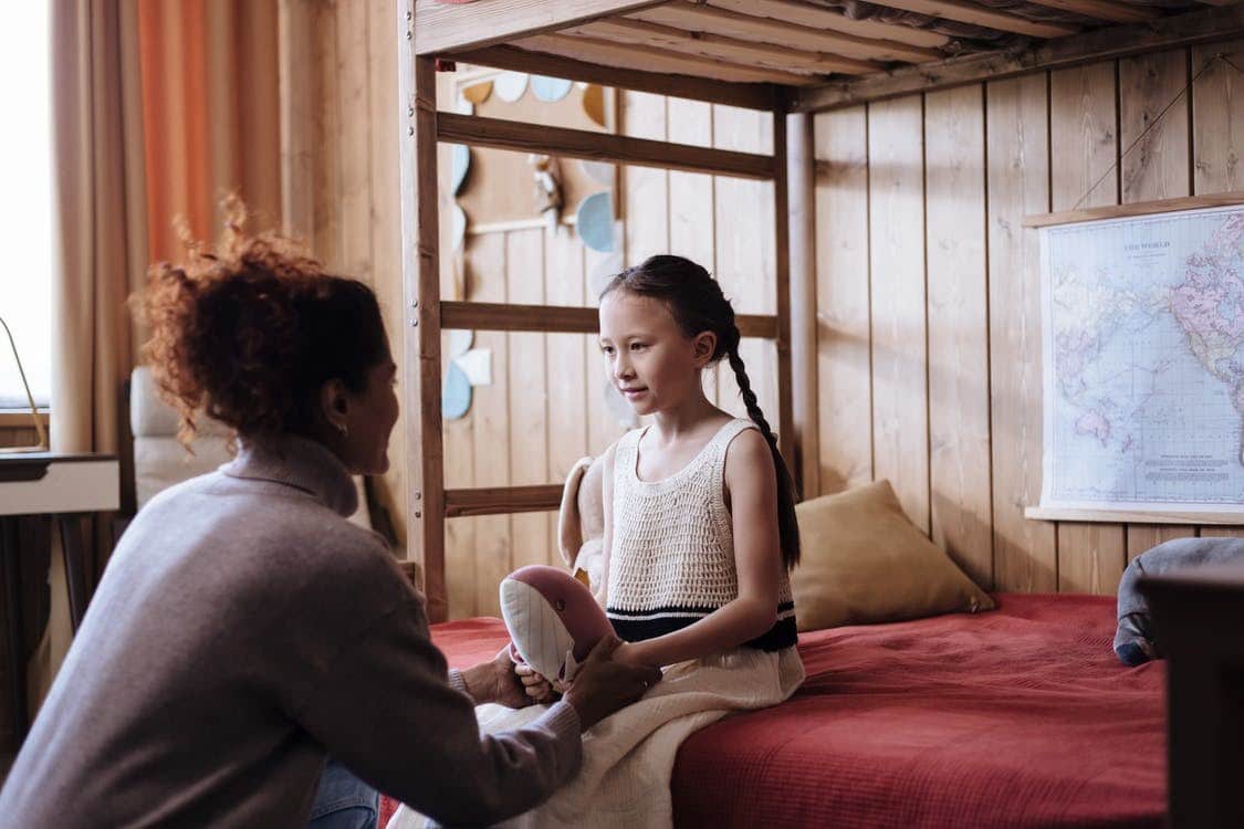 a mother talking to her daughter