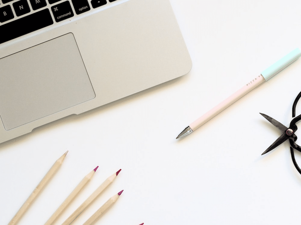 laptop-coloured-pencils-white-table-top