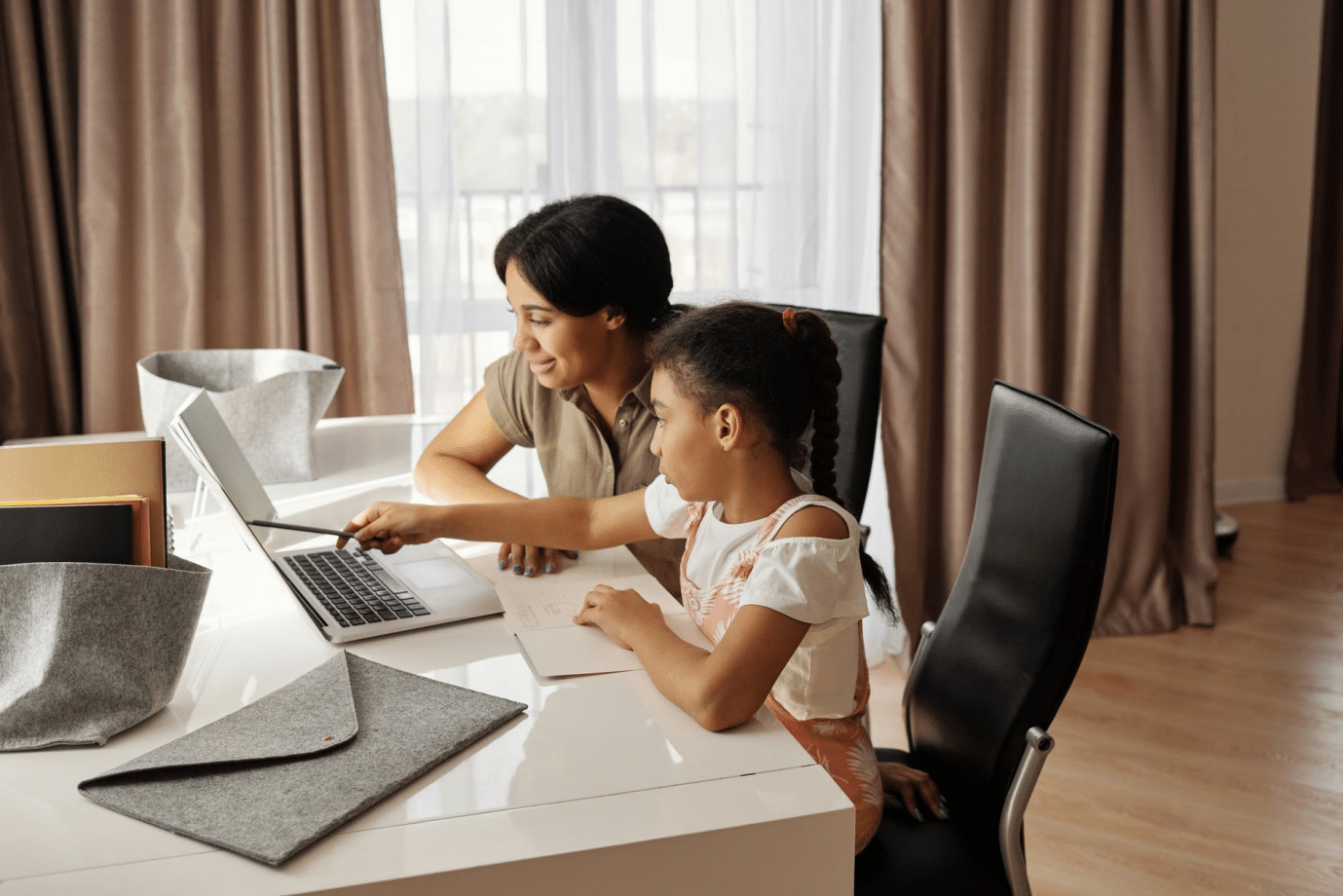 A student during an online class with a parent