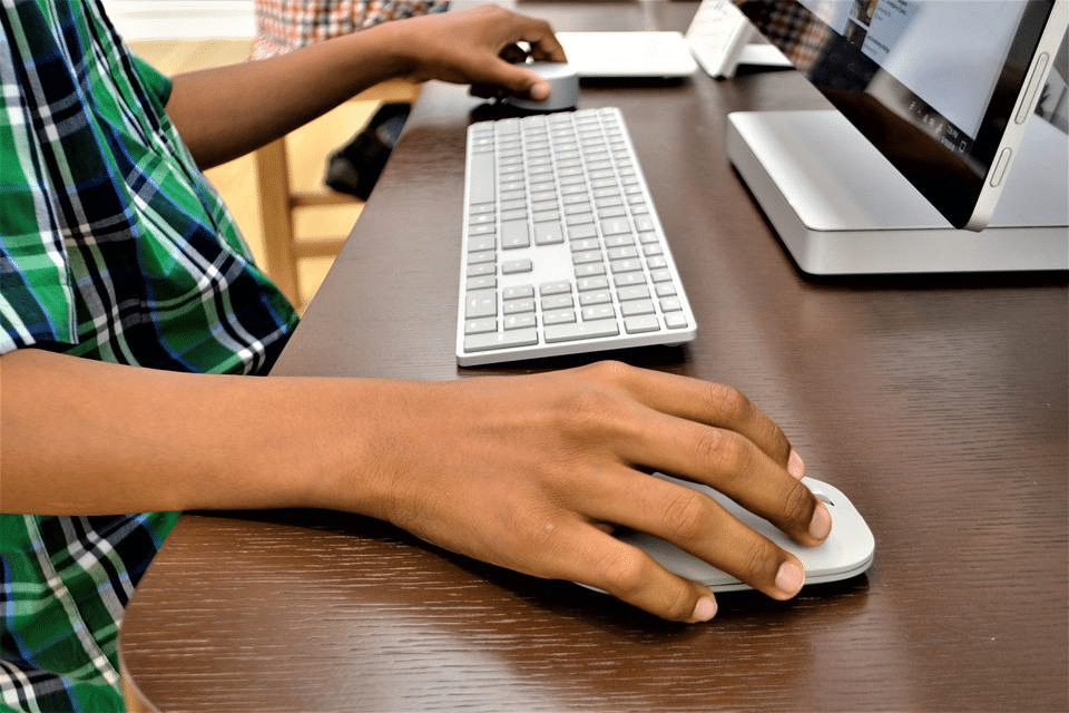 a student reviewing the Cambridge curriculum on a computer