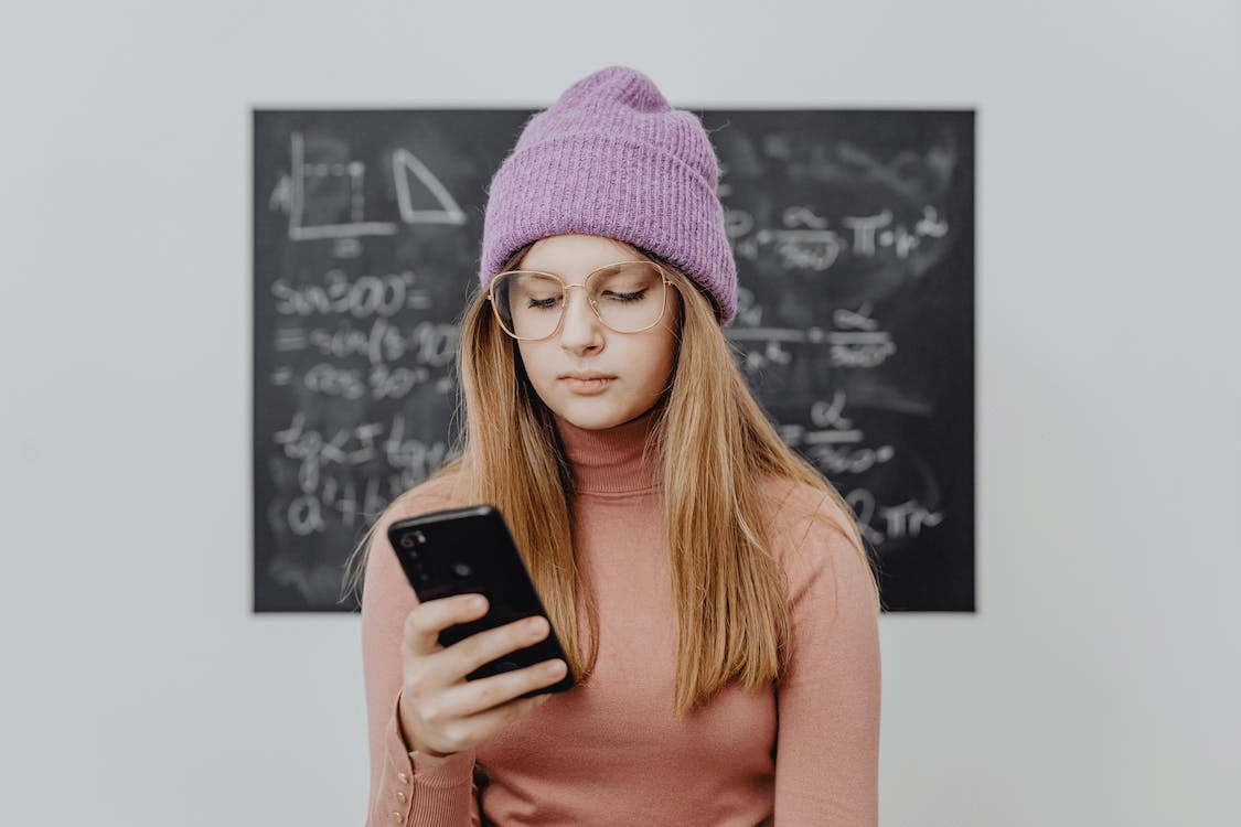 a student looking at her phone screen