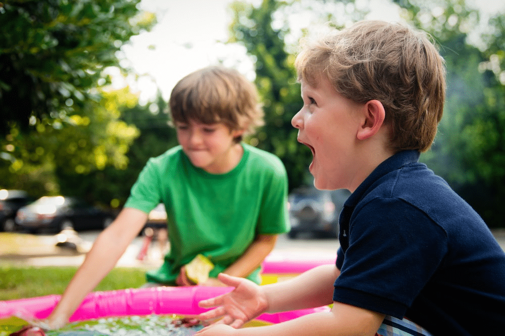 children playing in an inflatable pool