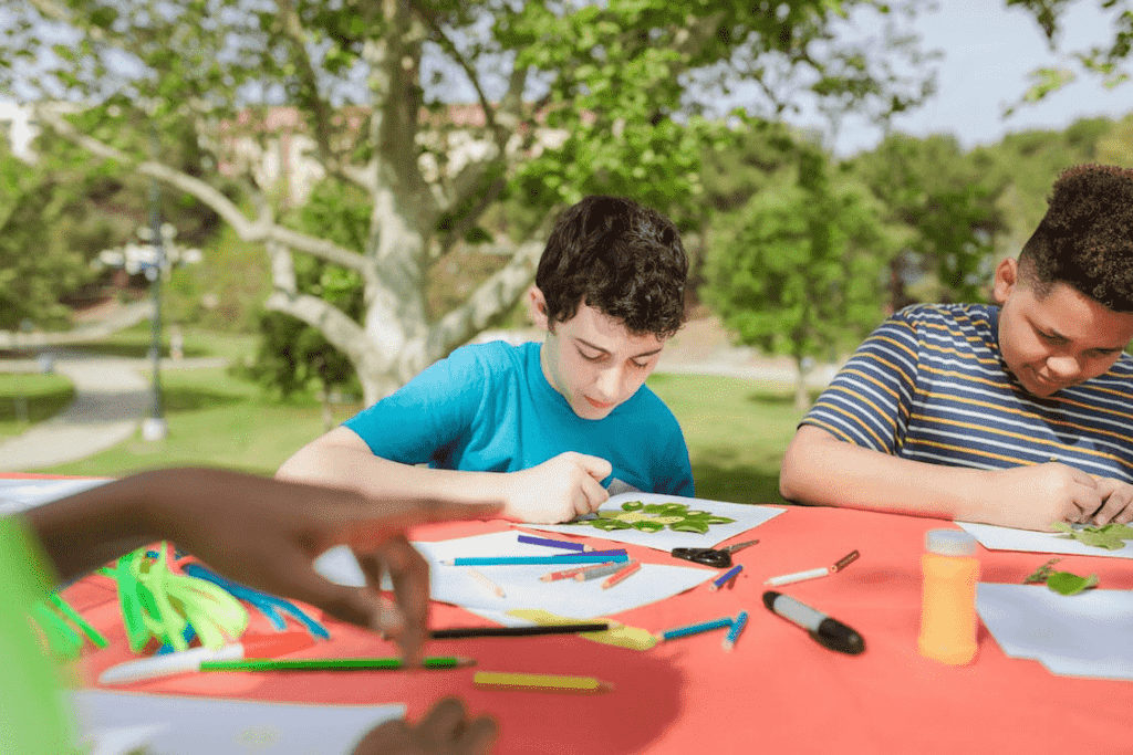 a young boy painting outside