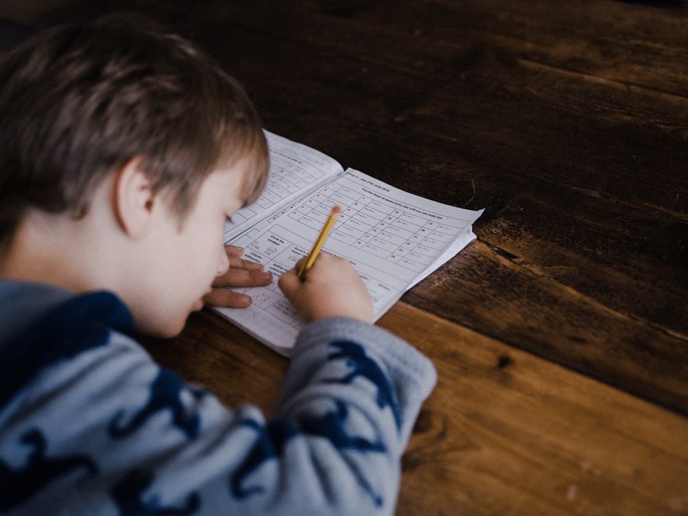 a young student completing his homework