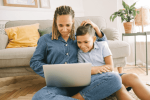 happy child and mom exploring the eLibrary at a top online British school