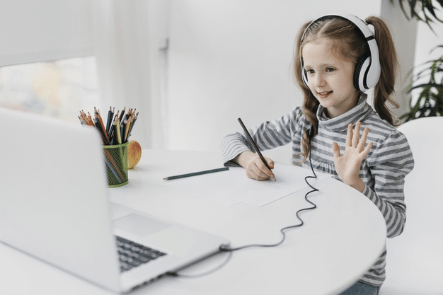 a child interacting with other pupils as she attends online school