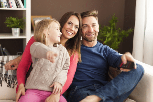 a child watching a science themed movie with her parents