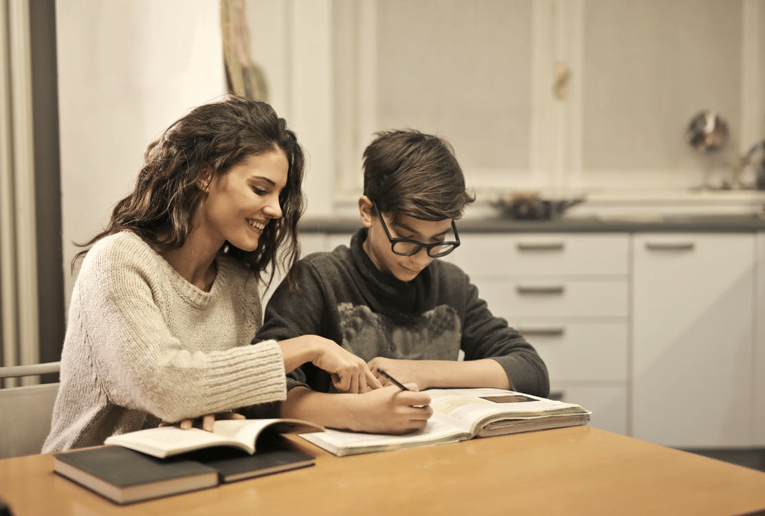 a mother assisting her child with homework