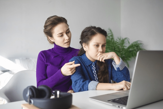 a mother discussing an online schooling plan with her daughter