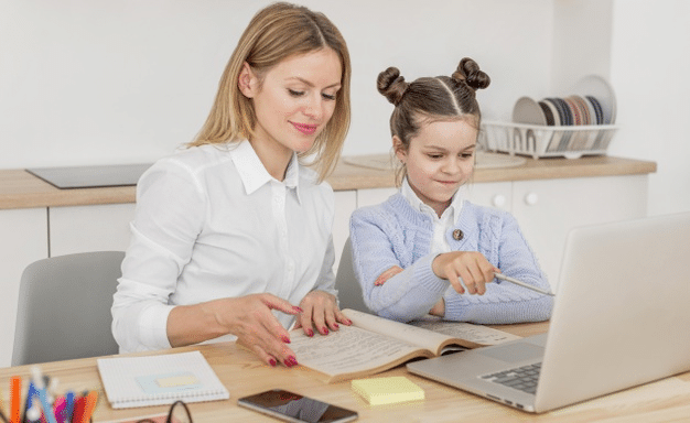 a parent helping her child navigate the first few days of online school