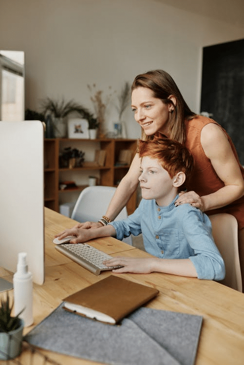 a parent helping her child revise after their online class