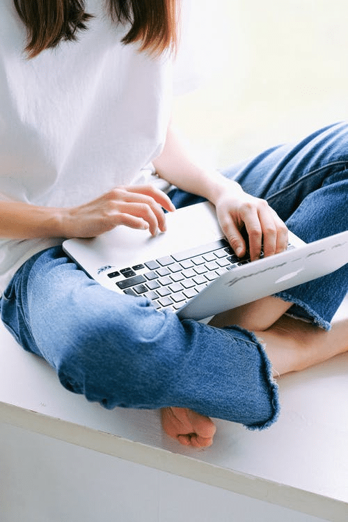 a student checking her online schooling schedule on her laptop