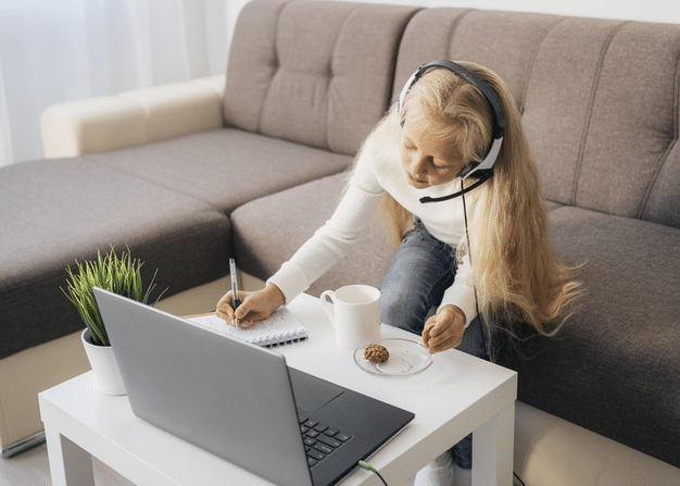 a student completing her homework after her online class