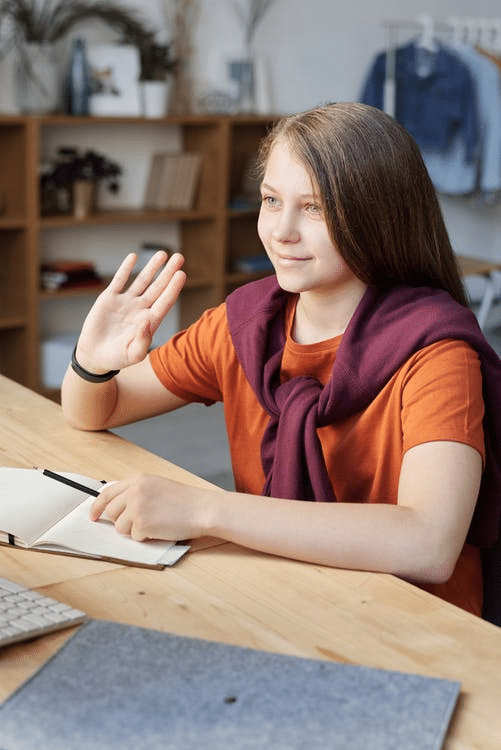 a student interacting with her peers as she attends online school