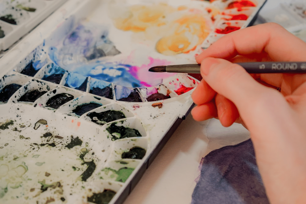 a student selecting a colour from a paint palette