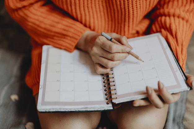 a student taking notes in her weekly planner