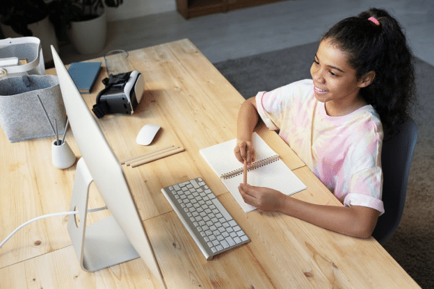 a young girl attending online school