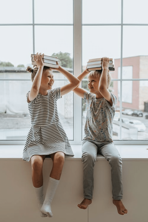 a young girl playing with her sibling