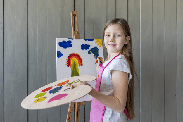 a young girl working on a painting project