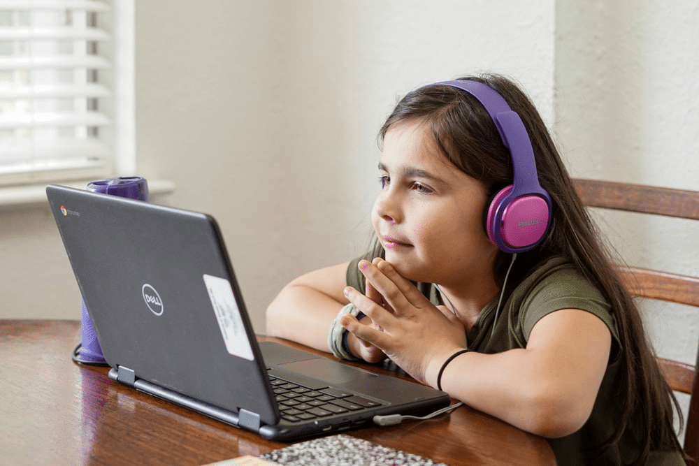 a young student attending an online class at home