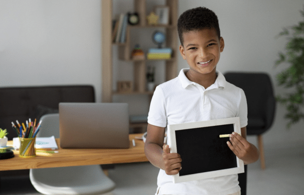 an Indian student smiling after his online class