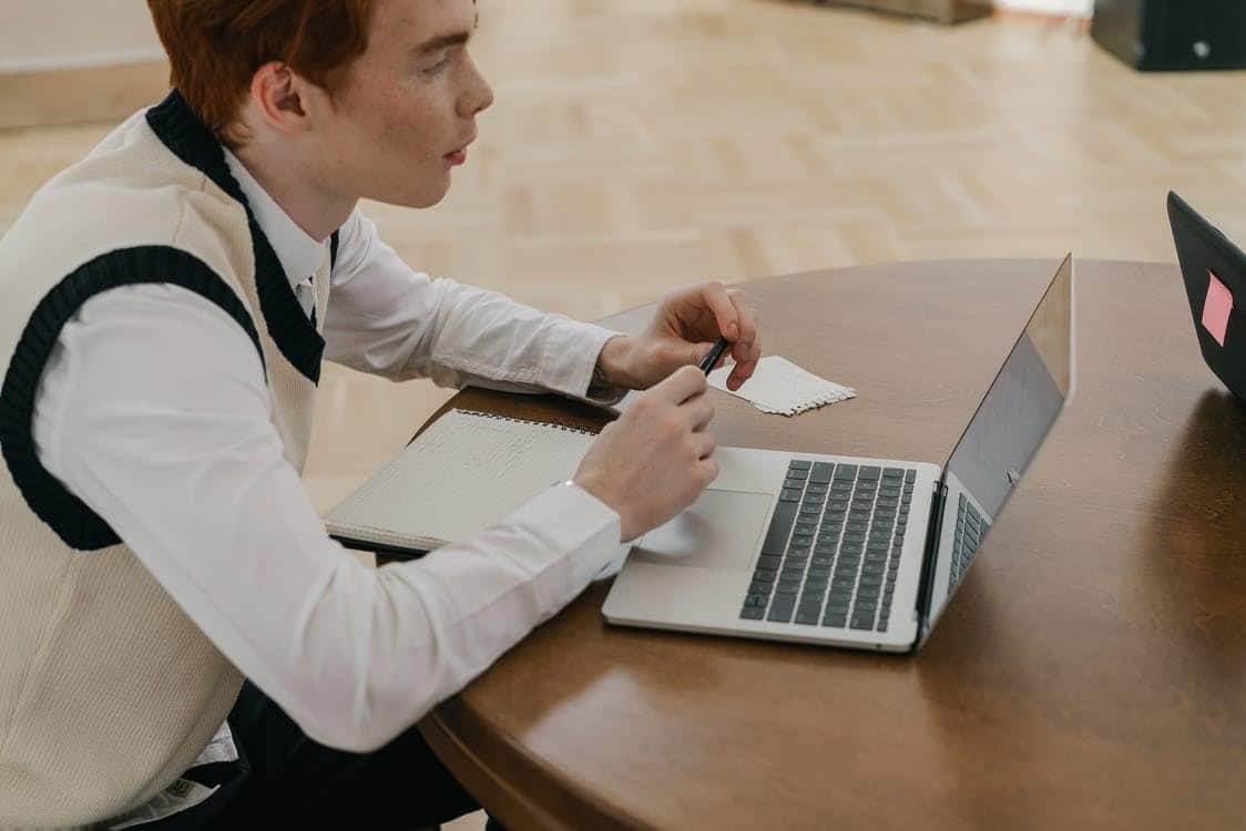 a student attending online school on his laptop