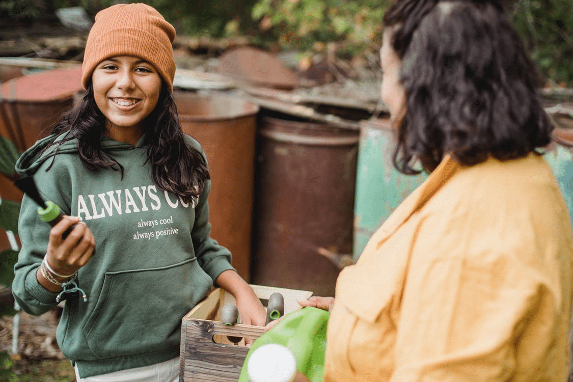 a teenager gardening with her mother