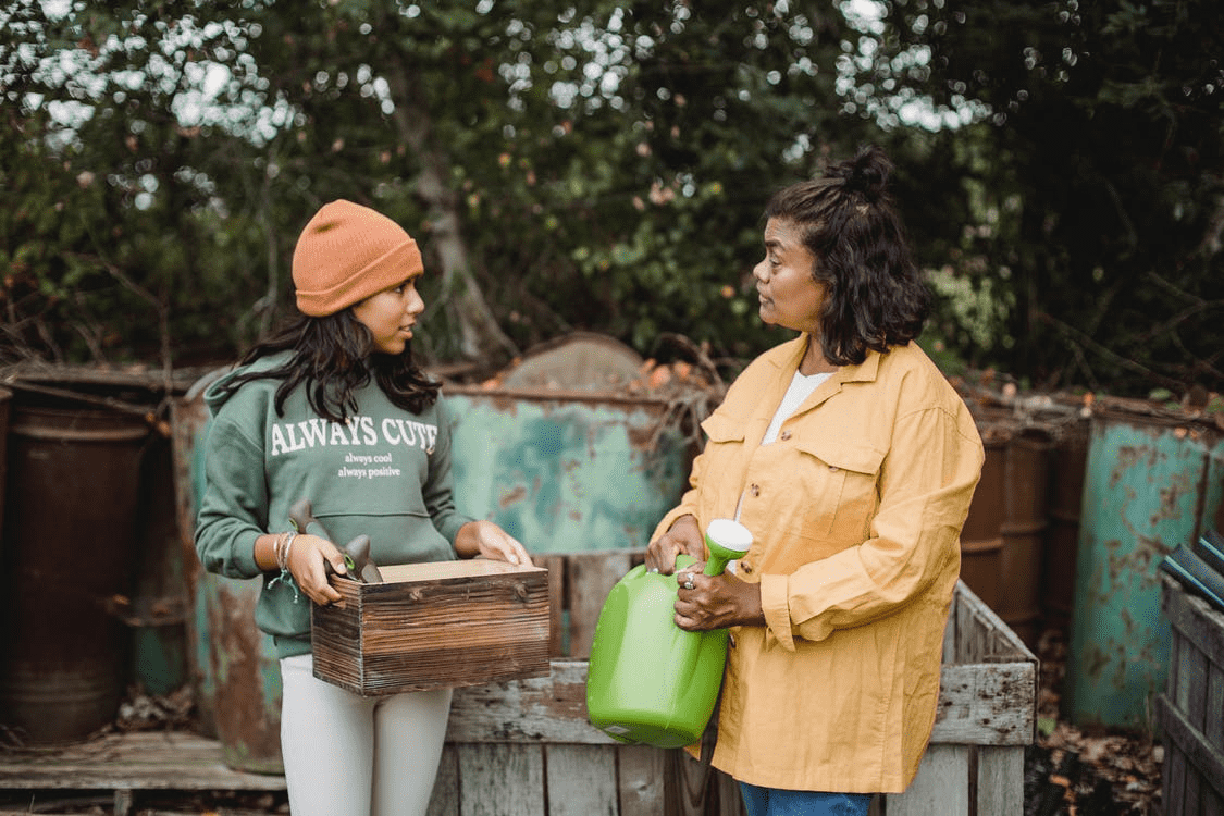 mother daughter gardening talking