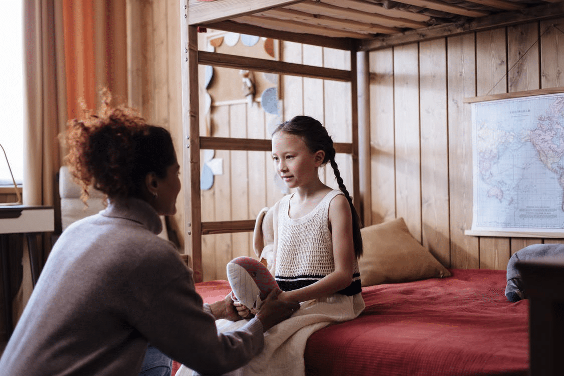 mother daughter talking bedroom