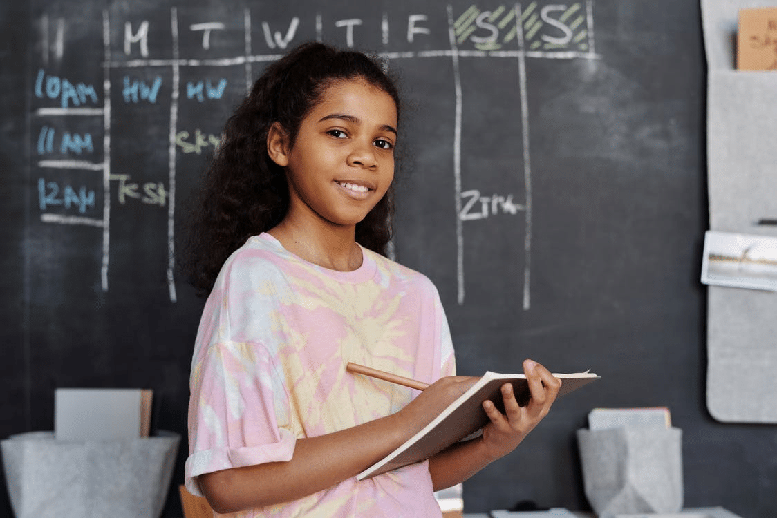 a student taking notes in a notebook