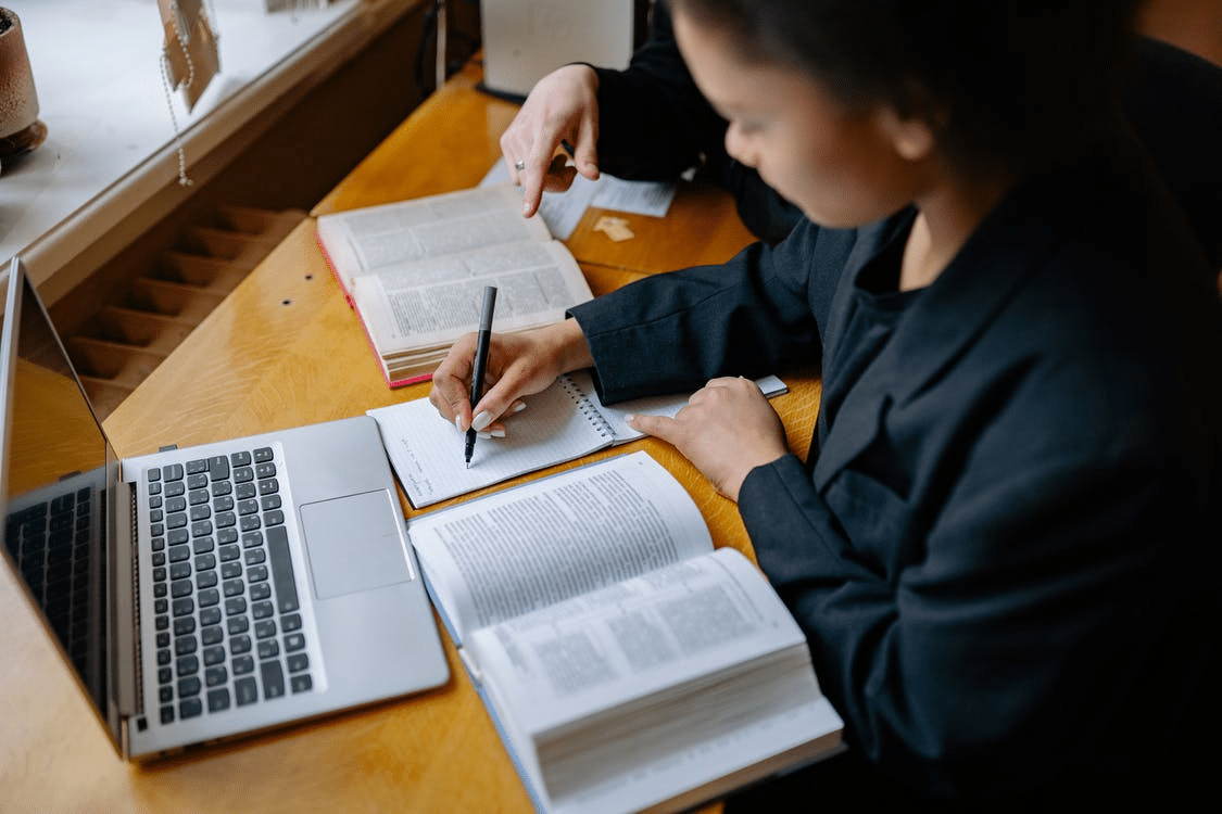 a girl taking notes during her first online class in Sharjah