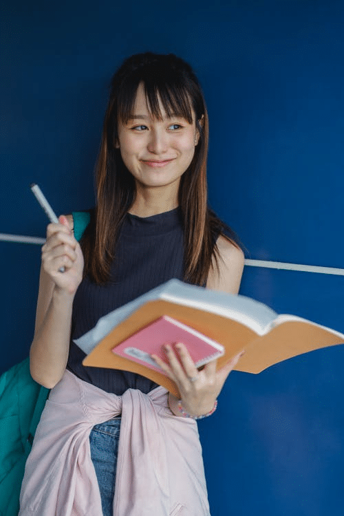 a student posing with a book in school