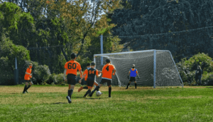 a group of teens playing soccer