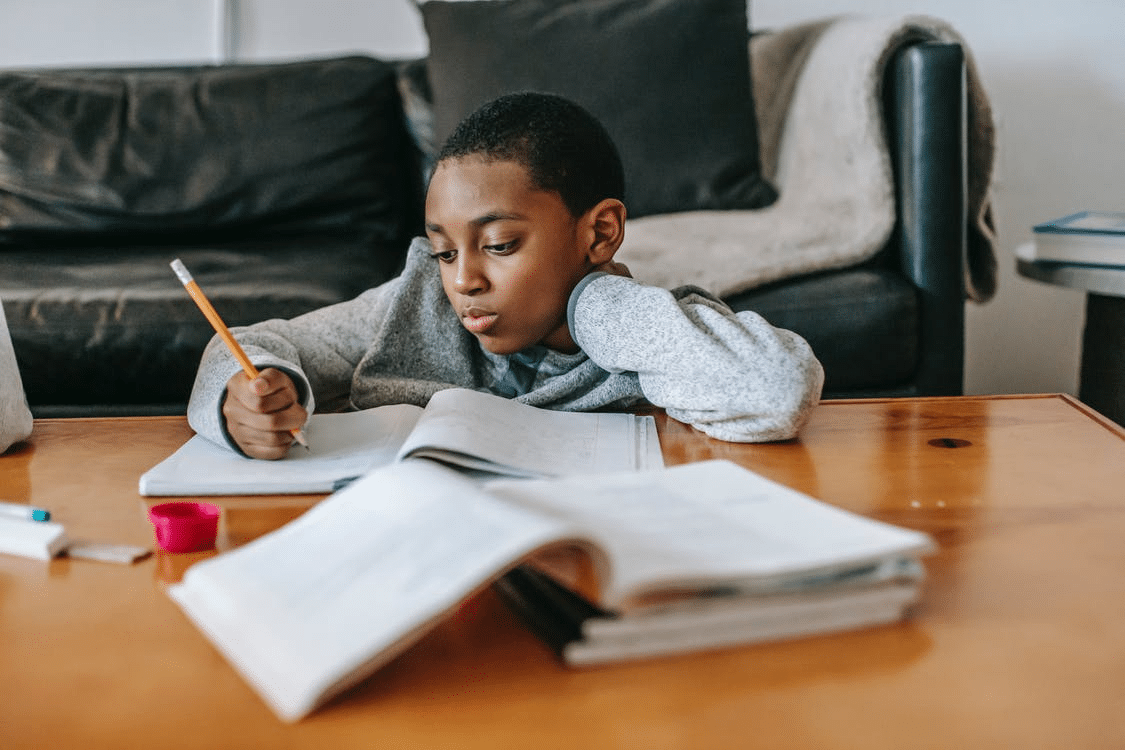 a young boy completing his homework in Faisalabad